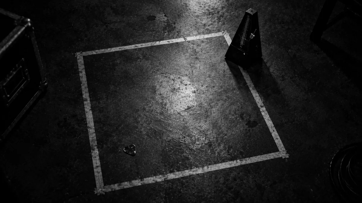 ① A 1 m square taped on the floor, and a metronome